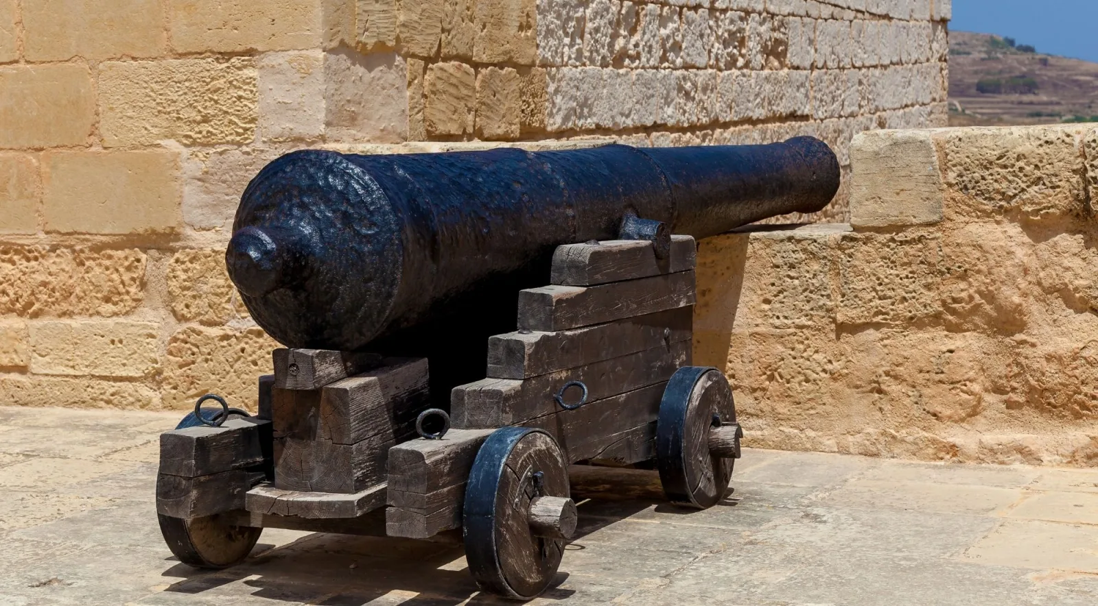 Historic iron cannon on a wooden carriage on the Citadel bastion in Victoria, Gozo