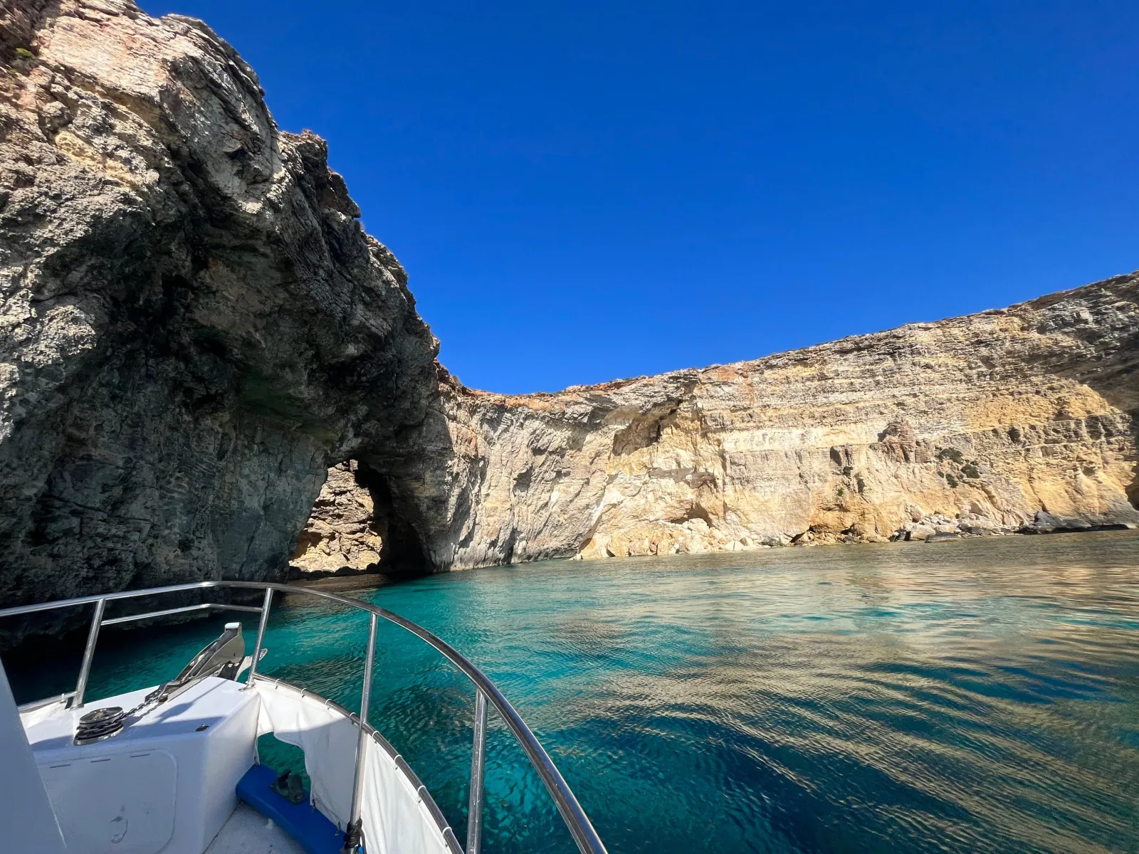 Boat passing close beneath the cliffs on the way to Comino from Gozo