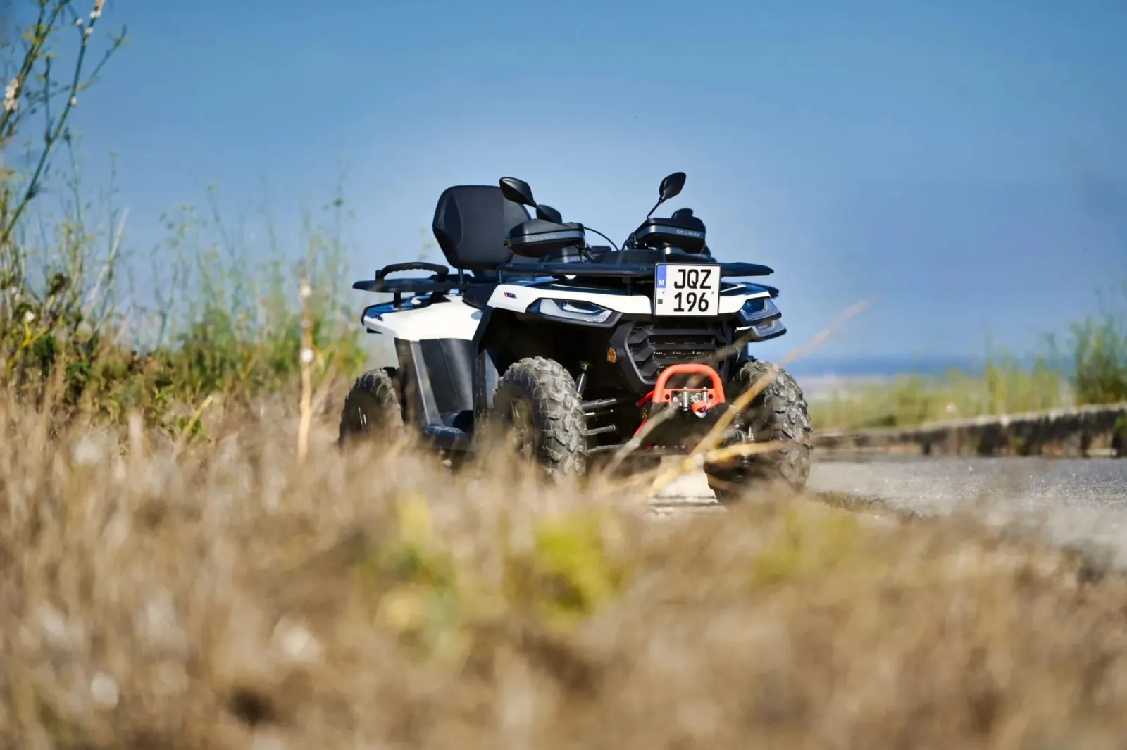 Rental quad bike parked in grass above the Gozo coastline