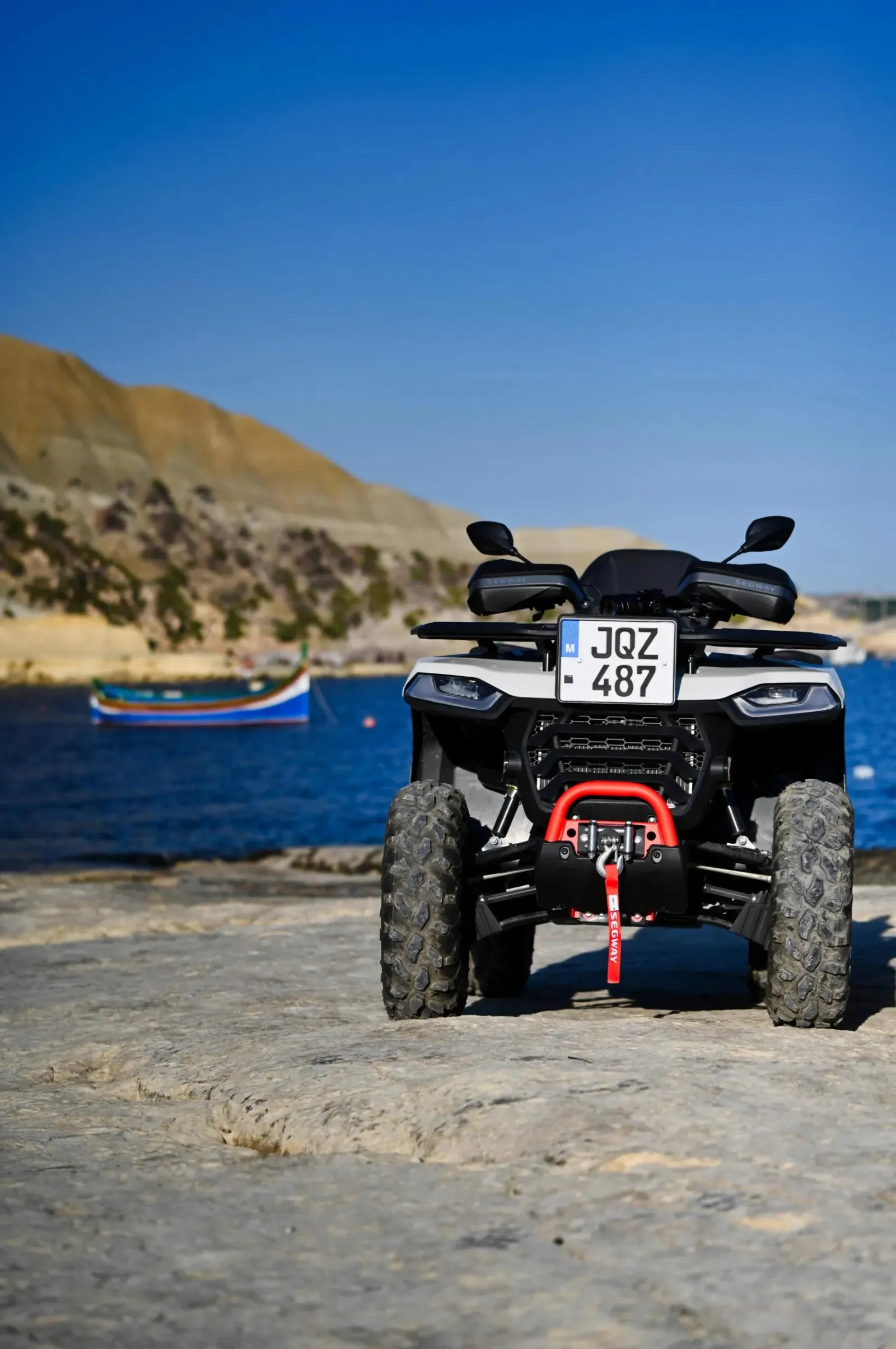 Quad bike on the flat coastal rock at a Gozo bay