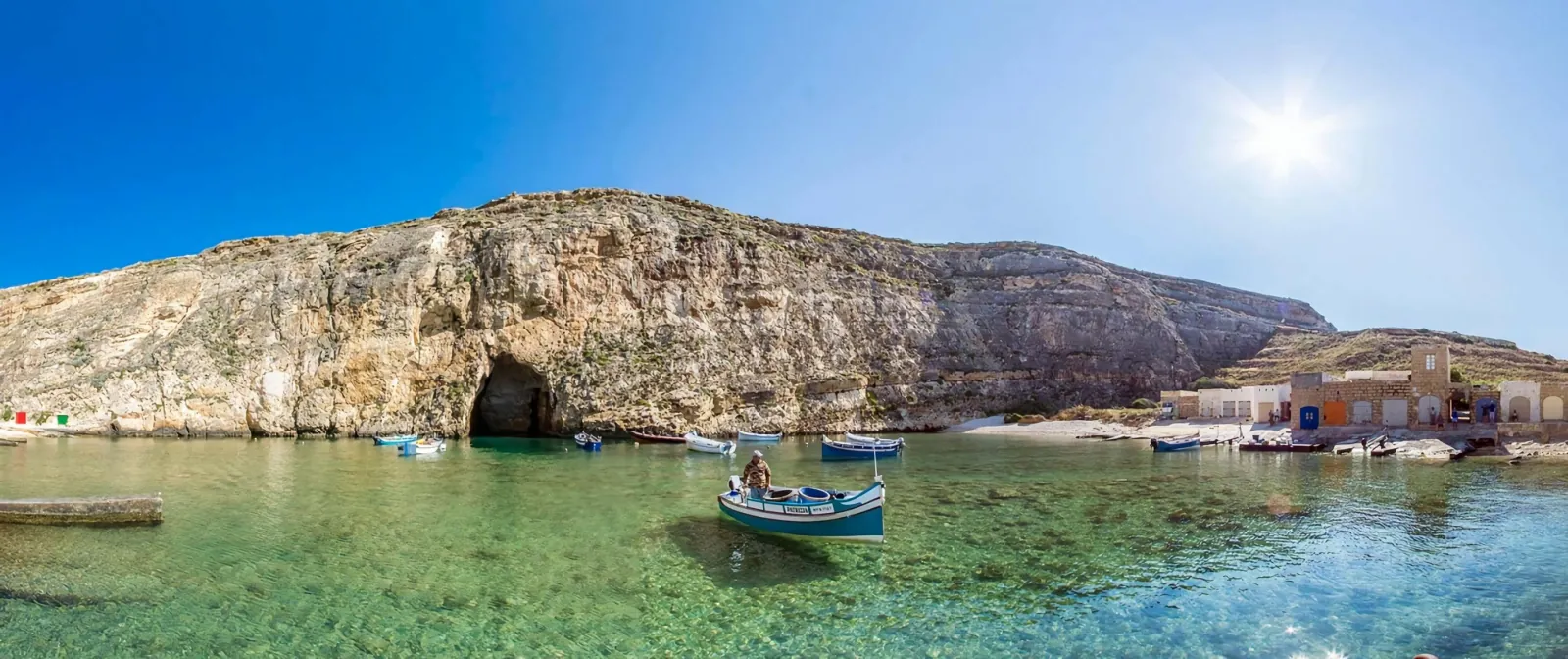 The Inland Sea at Dwejra on Gozo with a small boat moored inside the lagoon