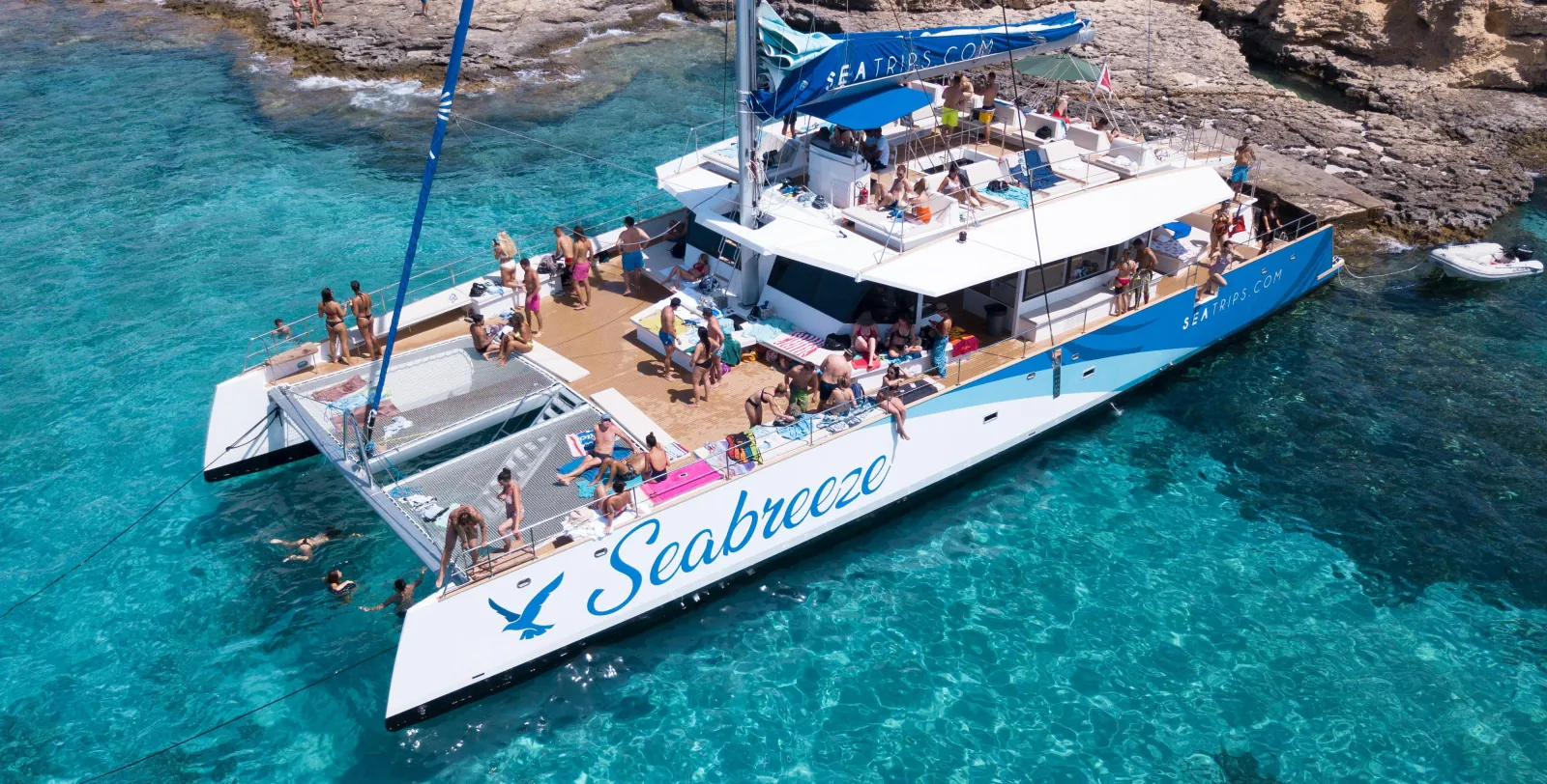 Passengers aboard a catamaran anchored off Comino on a Gozo and Comino cruise