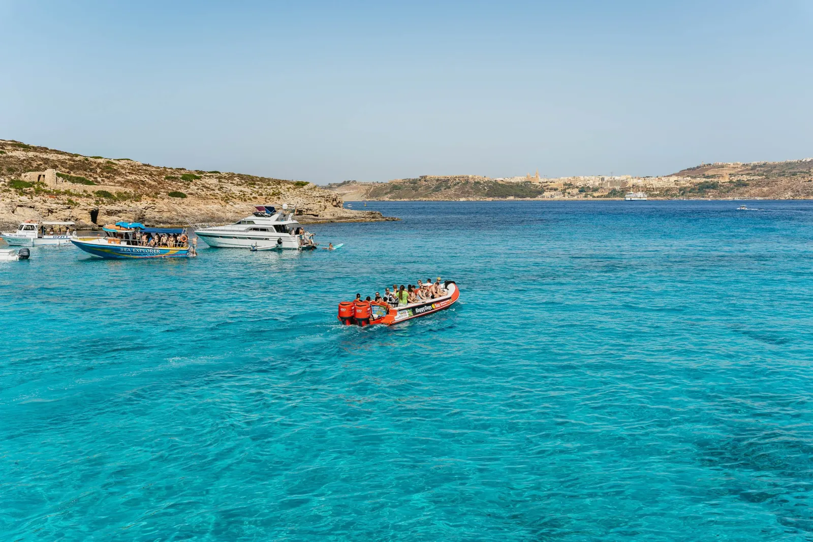 Boats on the clear turquoise water at Comino near the Blue Lagoon
