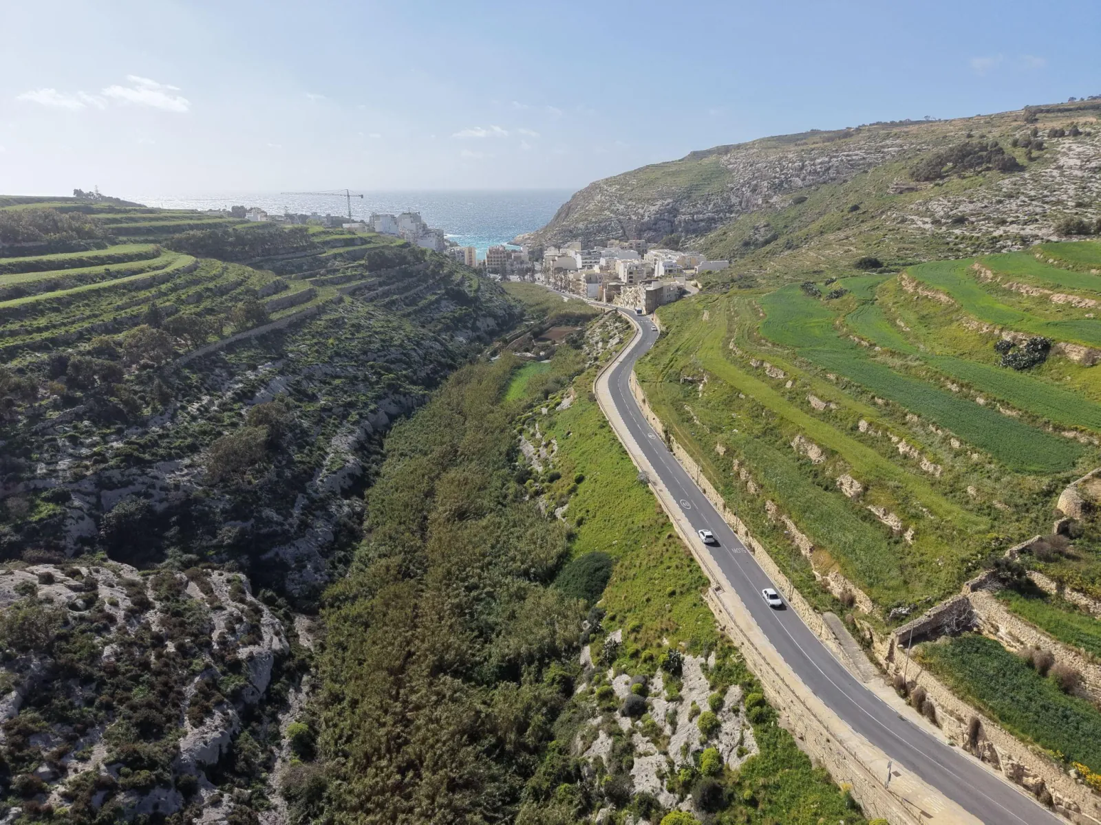 Aerial view of Gozo's terraced fields running down to the sea cliffs