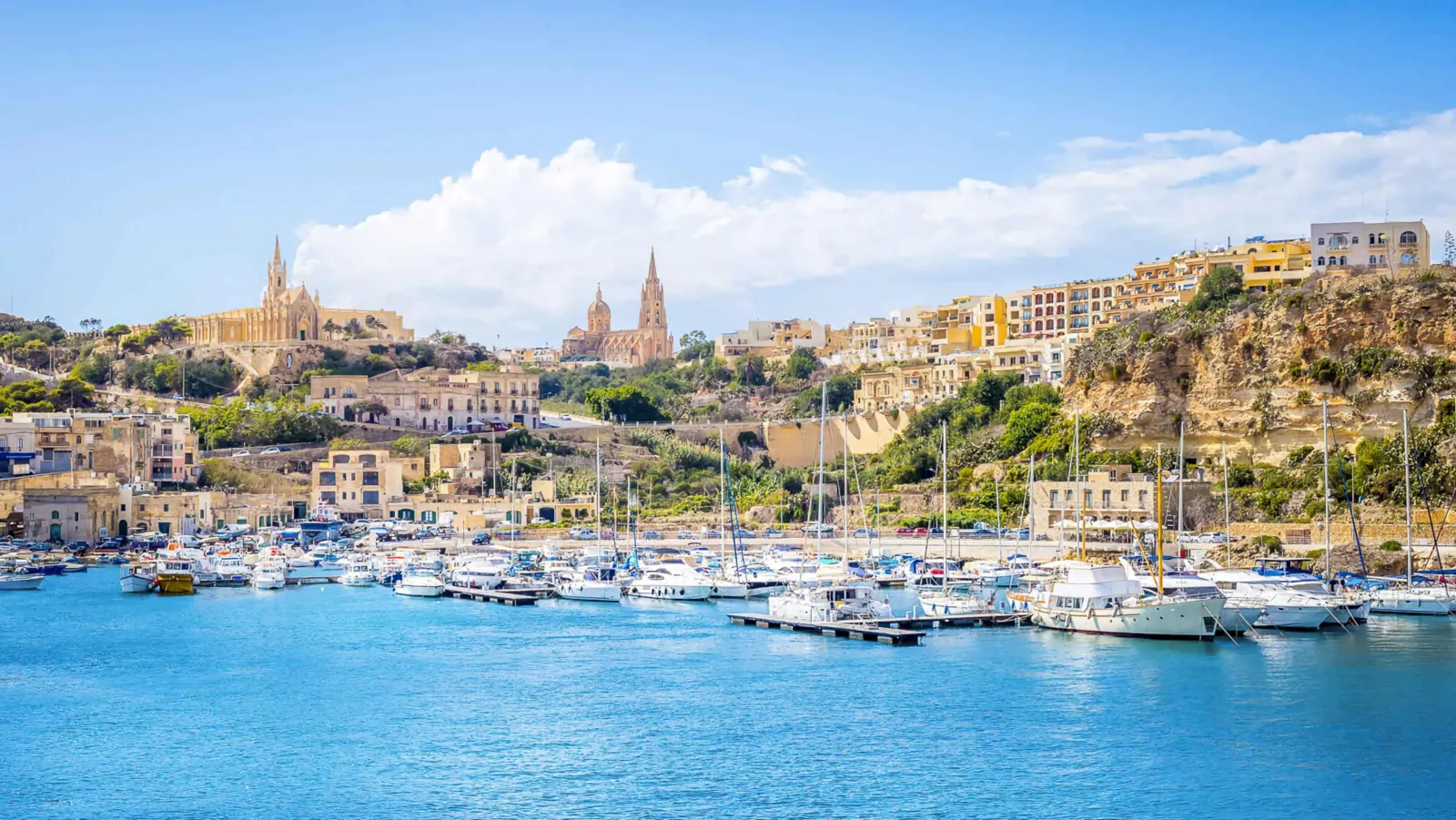 Mġarr Harbour on Gozo seen from the sea, with the church above the quay