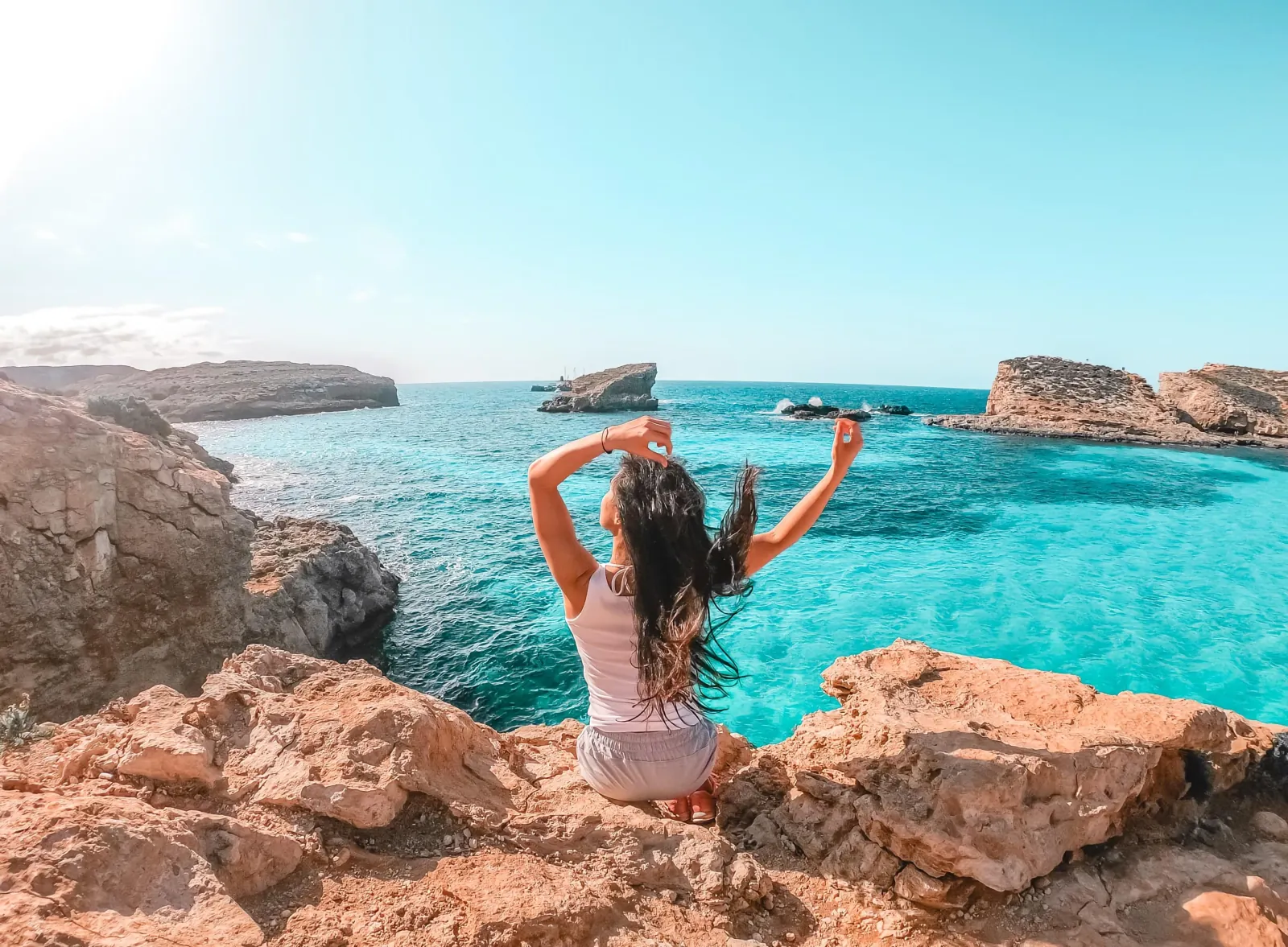 Visitor on the rocks above the Blue Lagoon at Comino