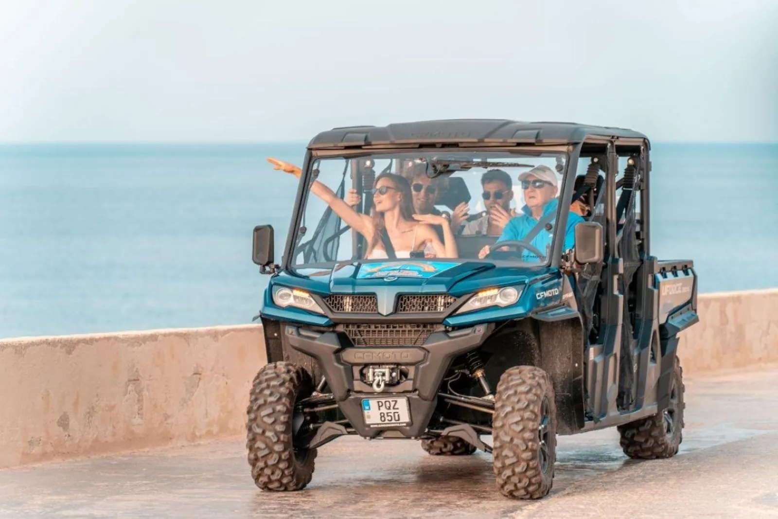 Guests riding a private open 4x4 along a Gozo sea wall