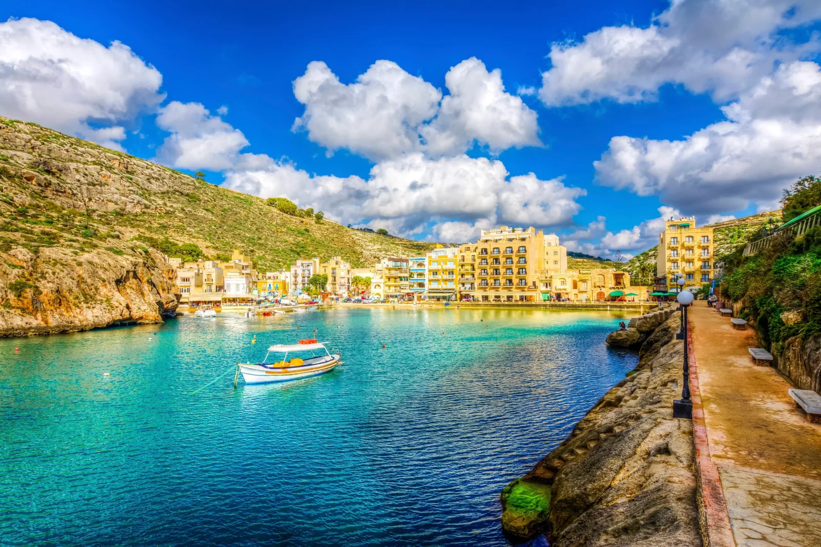 Turquoise water and waterfront buildings at Xlendi Bay on Gozo