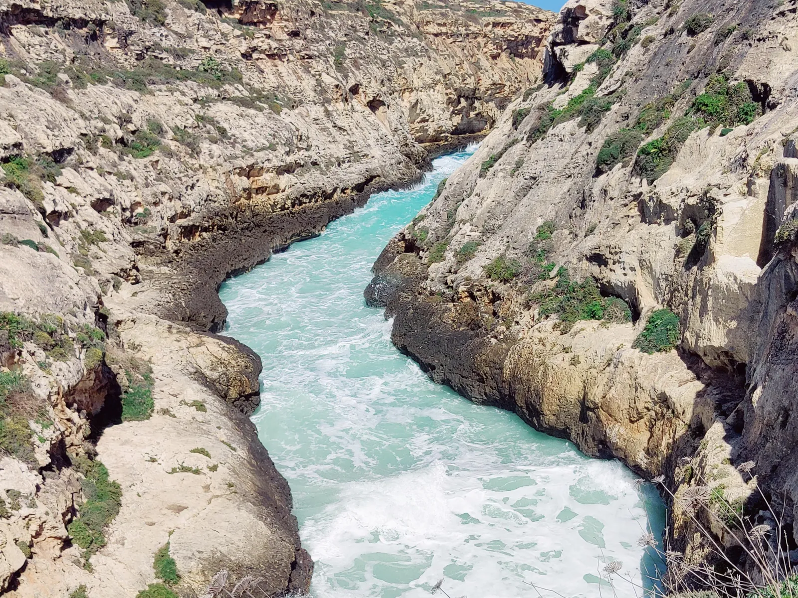 The narrow gorge at Wied il-Għasri cutting down to the sea on Gozo